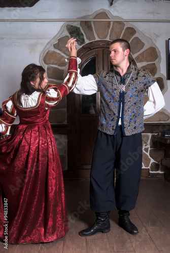 Attractive couple in retro dresses dance