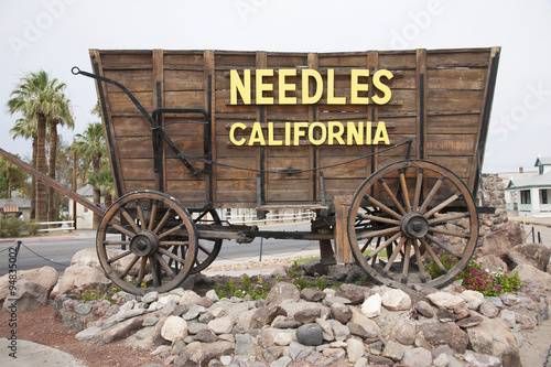 Covered wagon welcomes drivers to Needles California sign and Route 66, California .