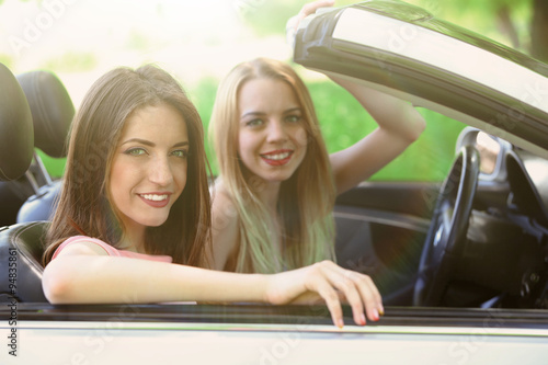 Two girls in cabriolet, out...