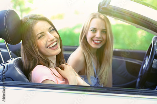 Two girls in cabriolet, outdoors © Africa Studio