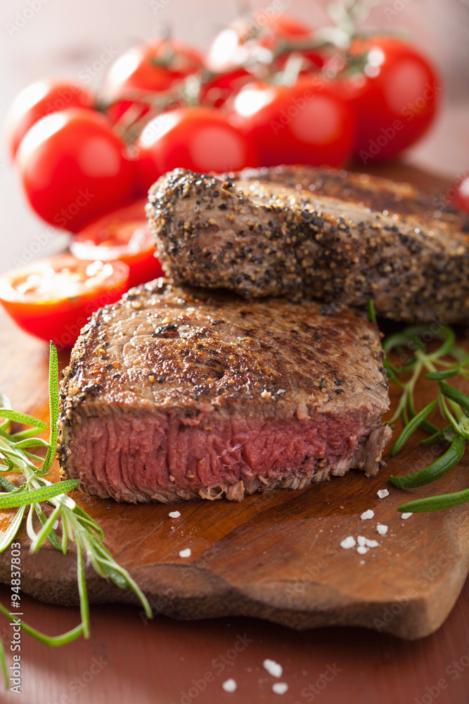 beef steak with spices and rosemary on wooden background beef steak with spices and rosemary on wooden background