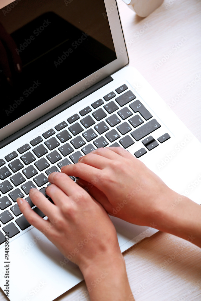 Woman using laptop on workplace close up Woman using laptop on workplace close up