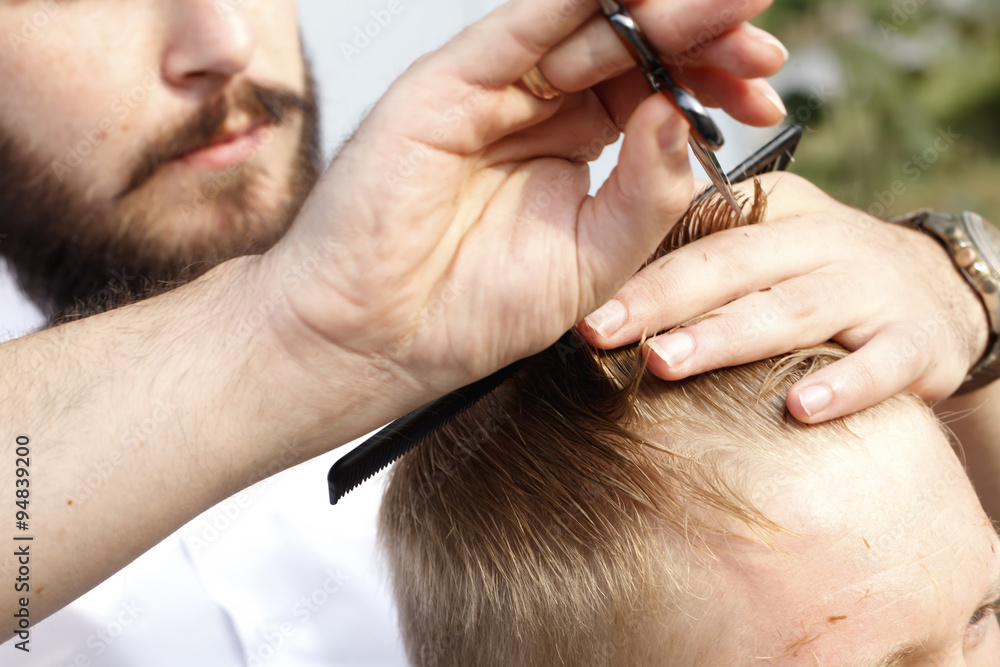 master hairdresser and stylist in the working process master hairdresser and stylist in the working process