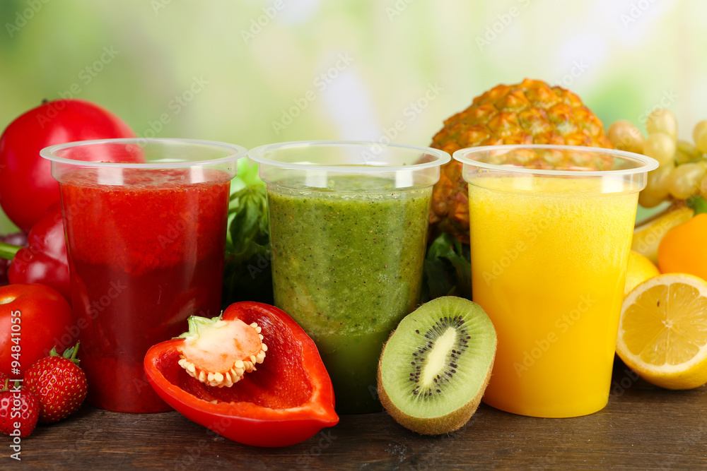 Fresh juice mix fruit, healthy drinks on wooden table, on bright background Fresh juice mix fruit, healthy drinks on wooden table, on bright background
