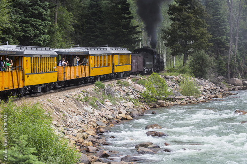 The Durango and Silverton Narrow Gauge Railroad Steam Engine travels along Animas River, Colorado, USA, 07.08.2014