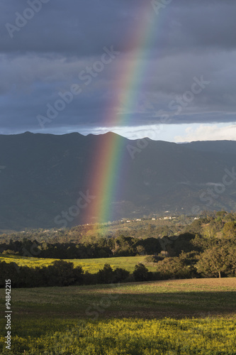 Oak View, California, USA, March 1, 2015, full rainbow over rain storm over mountains Ojai Valley