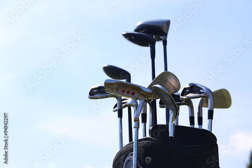 Golf bag with clubs on blue sky background