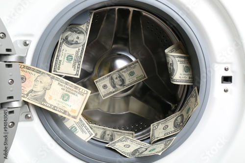 Money in washing machine, close up © Africa Studio