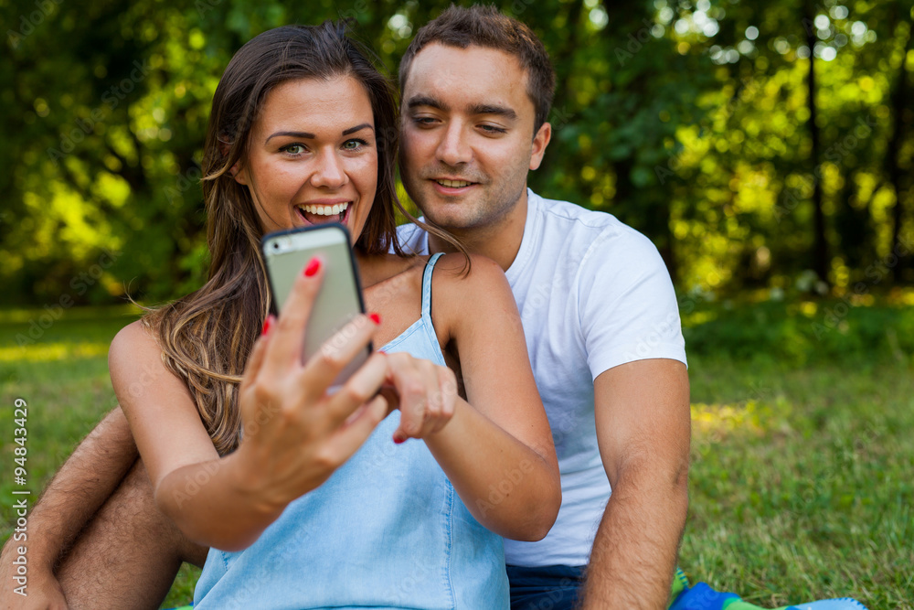 Pretty girl is showing something on smartphone to her boyfriend. Pretty girl is showing something on smartphone to her boyfriend.