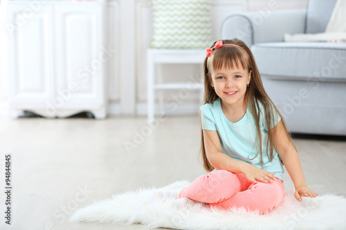 Little cute girl sitting on...
