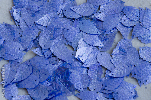 Blue sequins in the shape of leaves