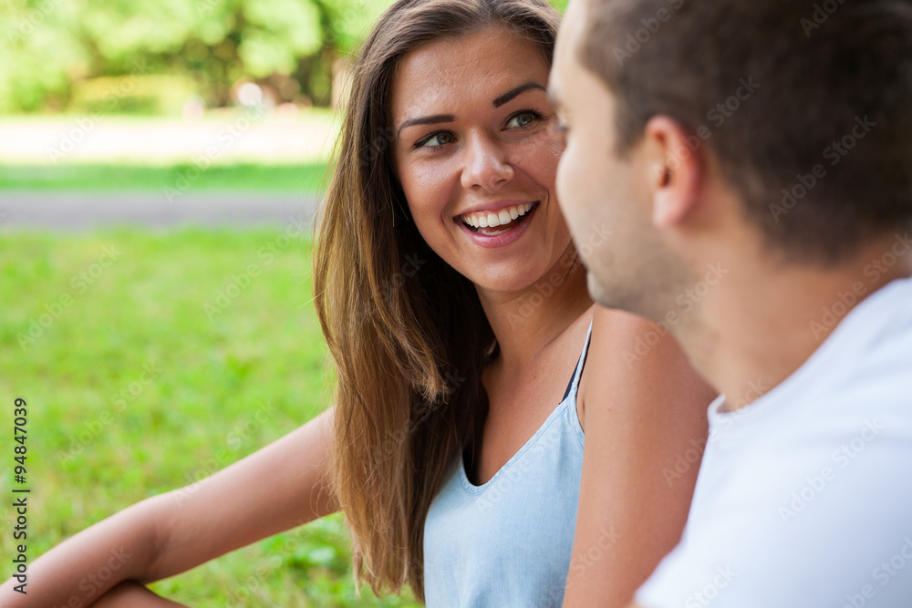 Pretty girl and her boyfriend are cuddling in park Pretty girl and her boyfriend are cuddling in park