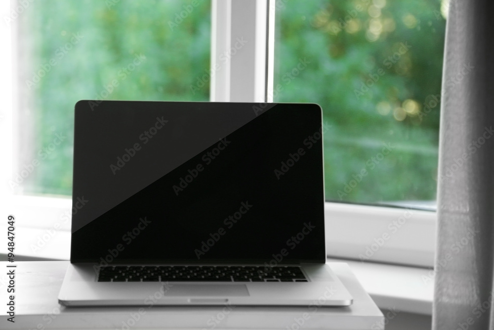 Desktop with notebook on window background Desktop with notebook on window background