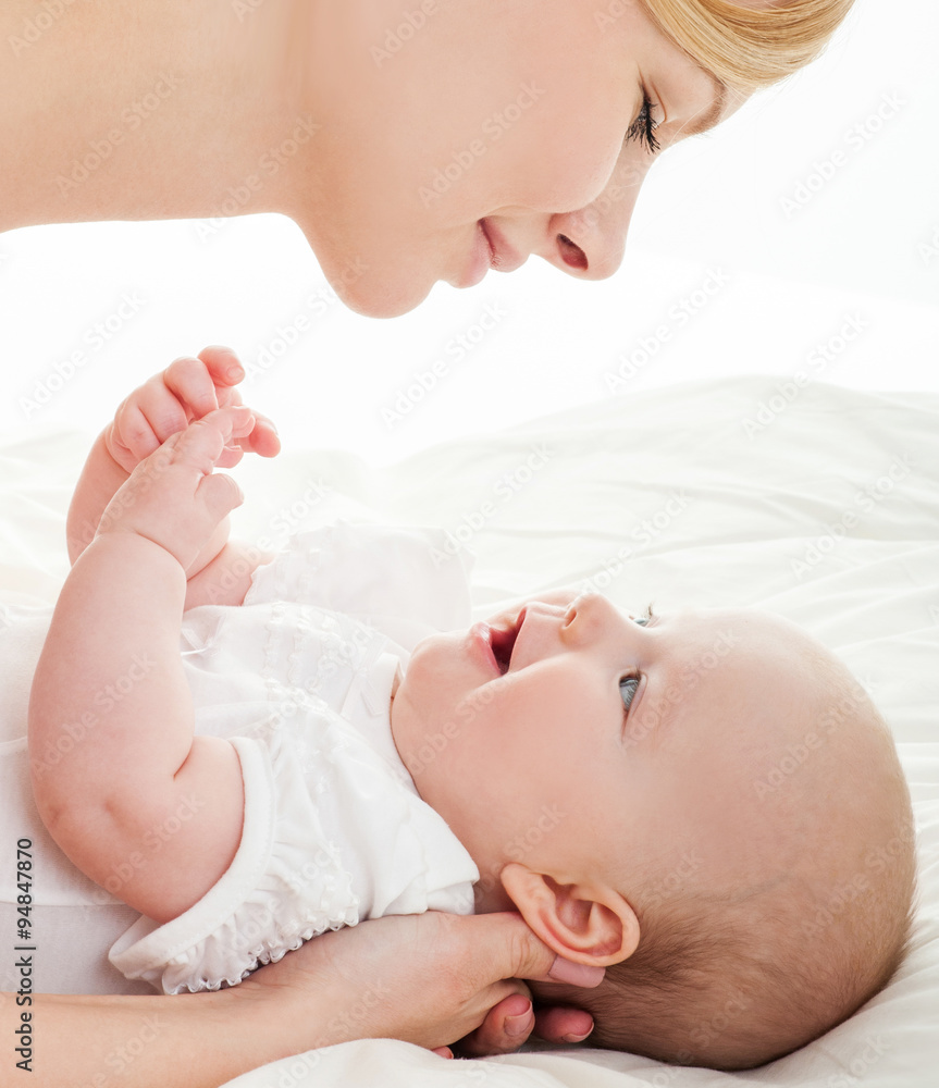 Mother and baby playing and smiling. Happy family. Mother and baby playing and smiling. Happy family.
