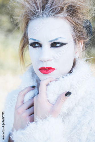 Fototapeta Naklejka Na Ścianę i Meble -  Ice princess, young woman with professional makeup posing outdoor