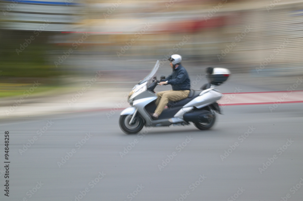 Man riding moped in Nice, France