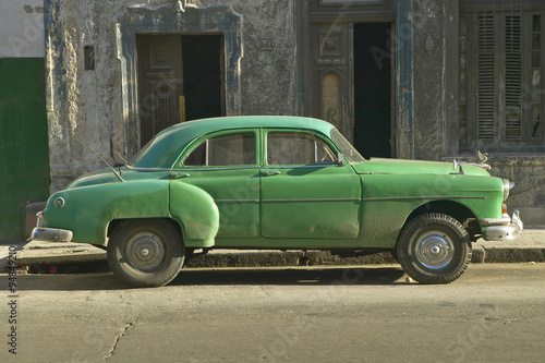 An old green car sitting in front of old building in Old Havana, Cuba © spiritofamerica