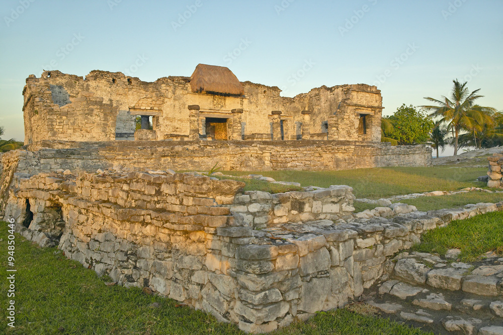 Mayan ruins of Ruinas de Tulum (Tulum Ruins) in Quintana Roo, Mexico in the Yucatan Peninsula, Mexico at sunset