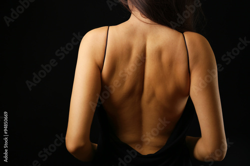 View on woman s back in open dress  close-up