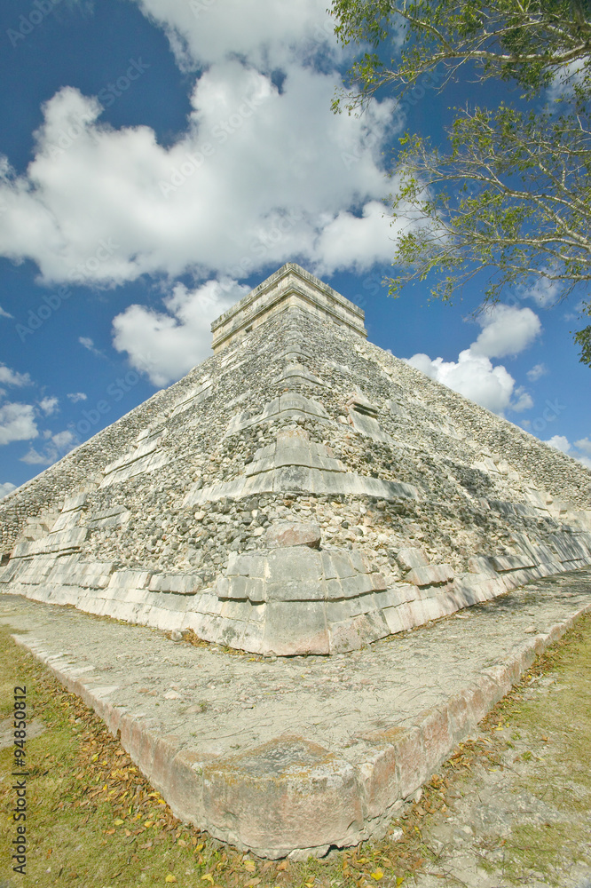 White puffy clouds over the Mayan Pyramid of Kukulkan (also known as El Castillo) and ruins at Chichen Itza, Yucatan Peninsula, Mexico