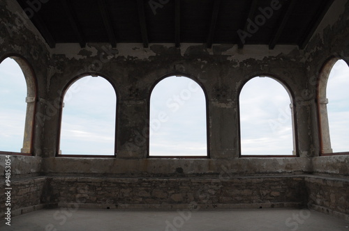arched windows in medieval fortress on the sea coast. Novigrad