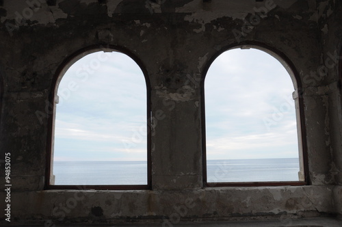 two arched windows in medieval fortress on the sea coast. Novigrad