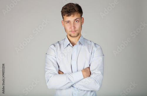 Young business man spitefully looks at his subbordinates with certain demand. © belokrylowa