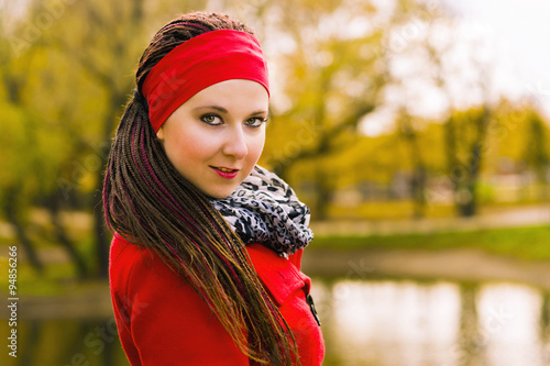 Portrait of a woman in hairstyle with braids in autumn