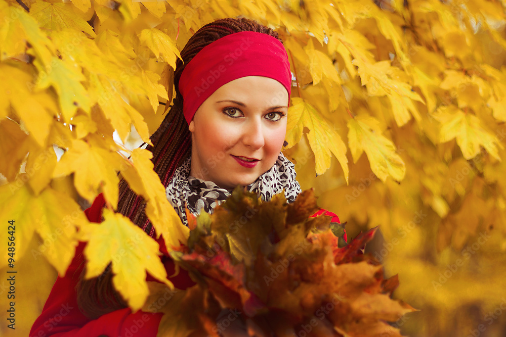 A woman among the colorful leaves - obrazy, fototapety, plakaty 