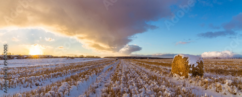 закат на сельском поле с сеном и первым снегом, Россия, Урал