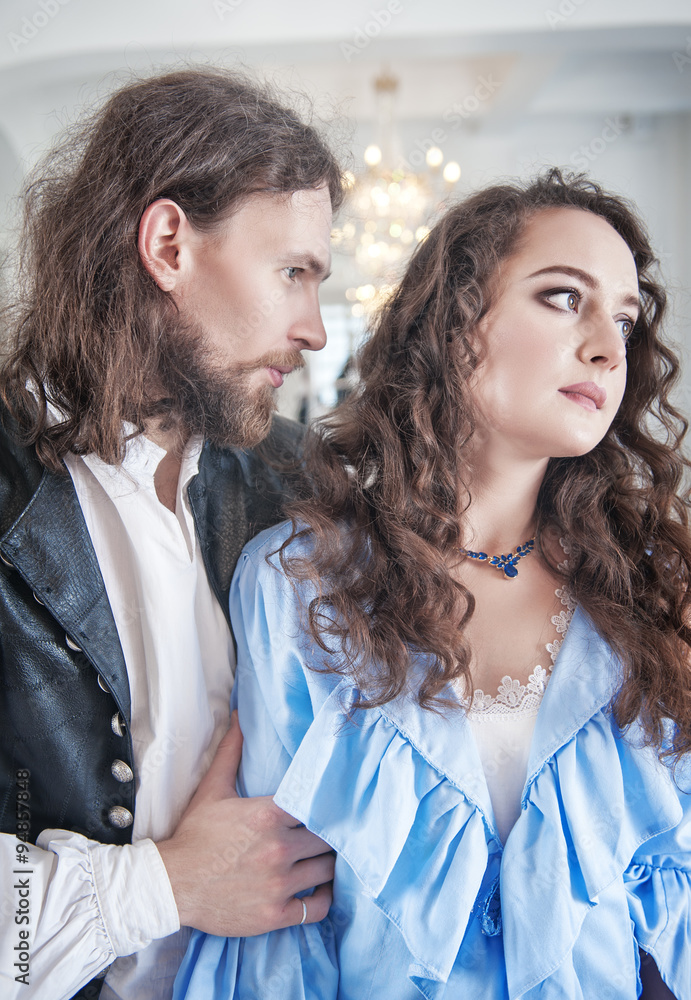 Beautiful passionate couple woman and man in medieval clothes Beautiful passionate couple woman and man in medieval clothes