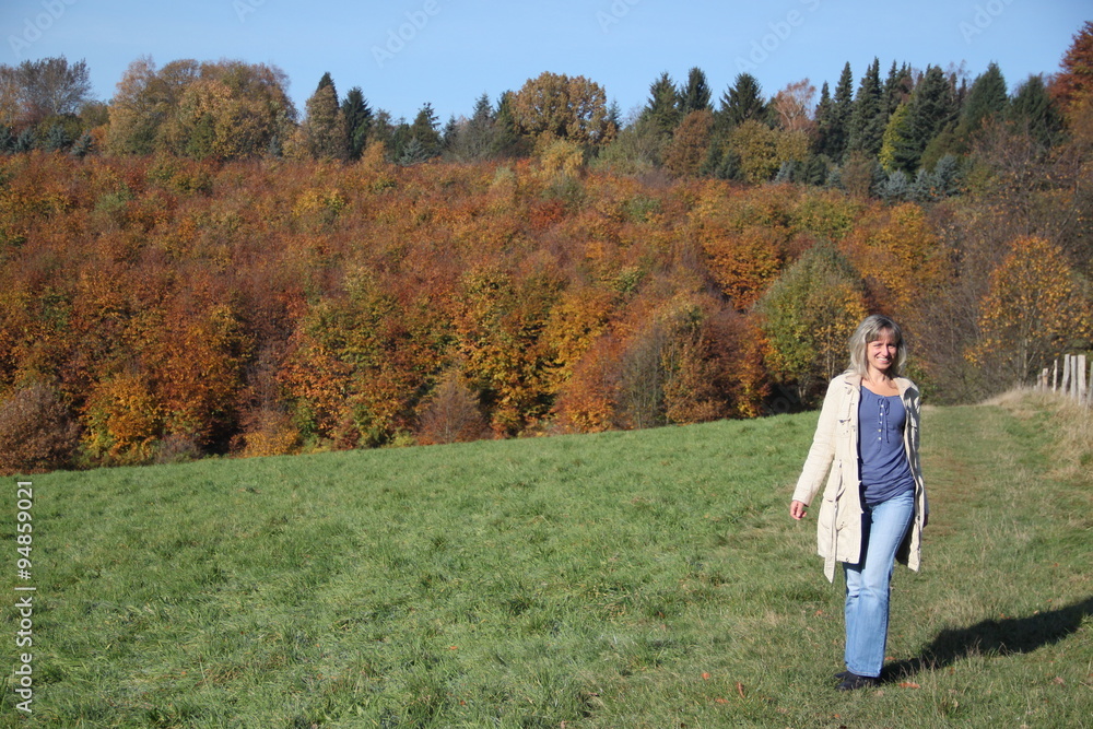 Frau wandert am Waldrand