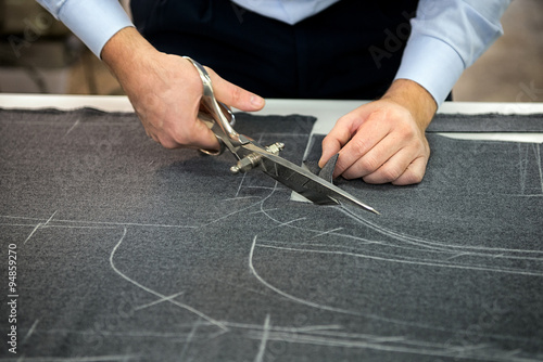 Tailor cutting fabric photo