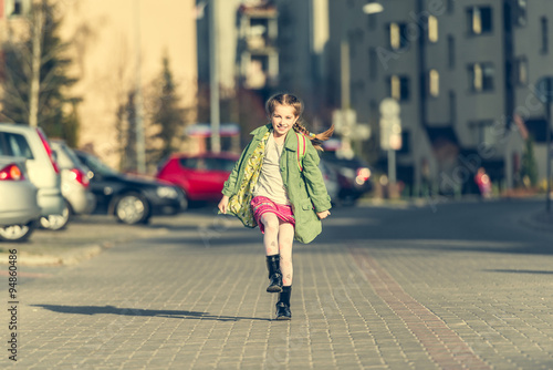 happy little girl running from school