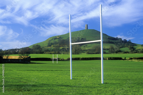 Glastonbury Tor, A sacred site along the English countryside in Glastonbury, England and goal posts in green field