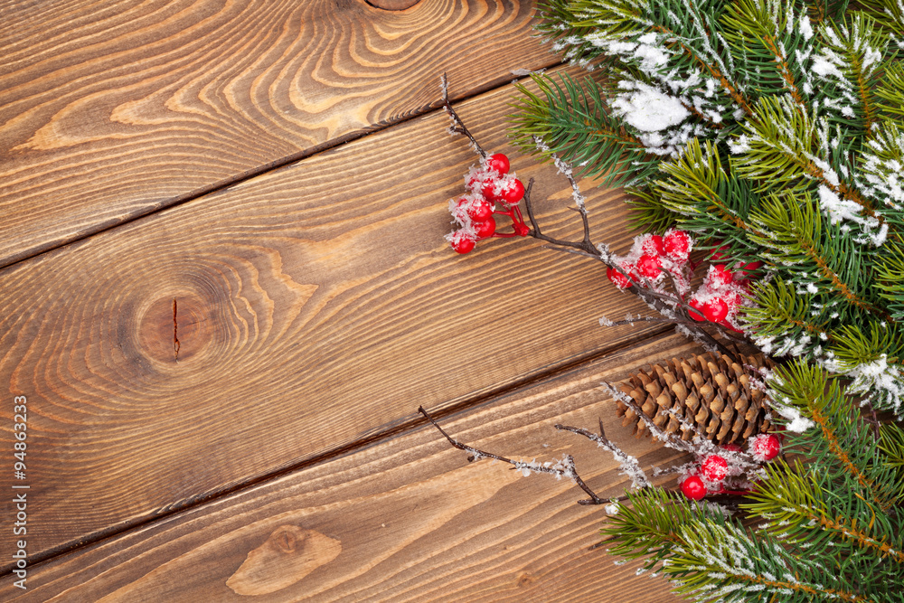 Christmas wooden background with snow fir tree and decor Christmas wooden background with snow fir tree and decor