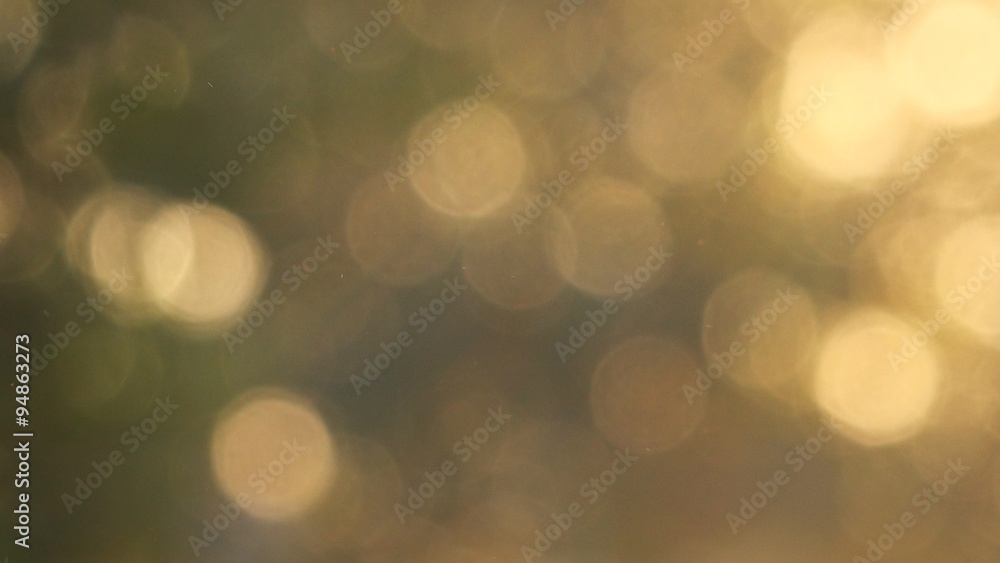 Abstract autumn bokeh background, glittering sunlight through yellow leaves on branches blurred as seasonal background. Abstract autumn bokeh background, glittering sunlight through yellow leaves on branches blurred as seasonal background.