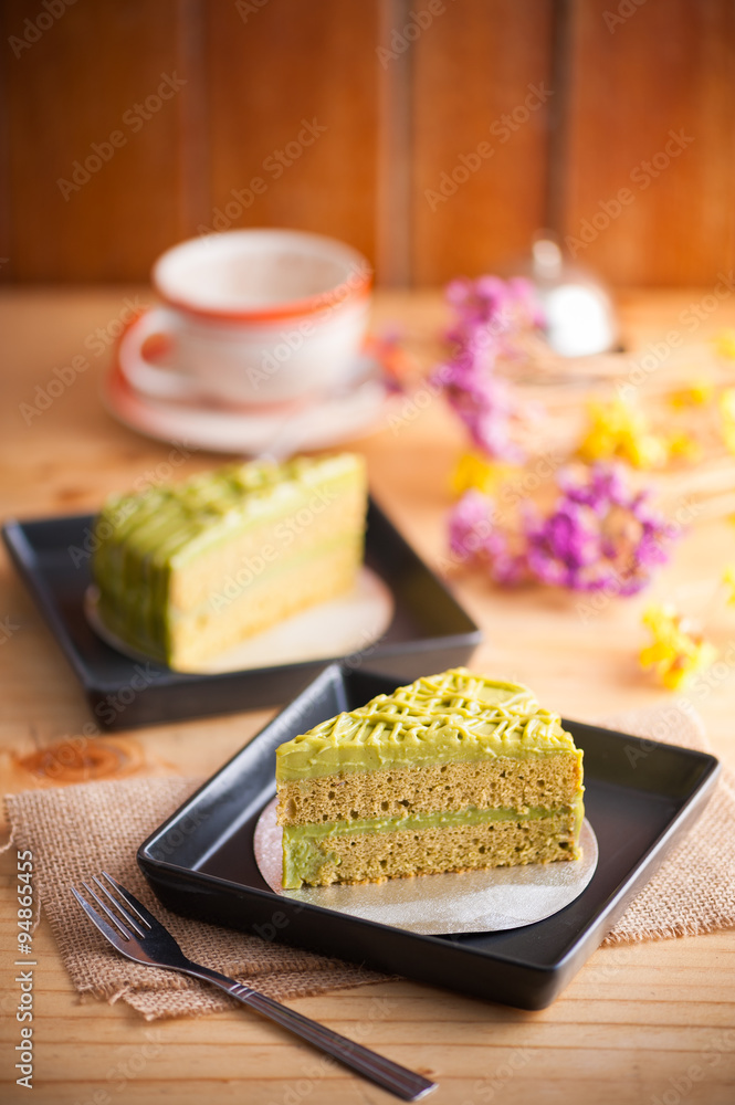 Green tea cake on wood table Green tea cake on wood table
