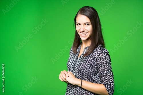 TV weather news reporter at work.News anchor presenting the world weather report.Television presenter recording in a green screen studio.Young woman with copy space on green screen chroma key