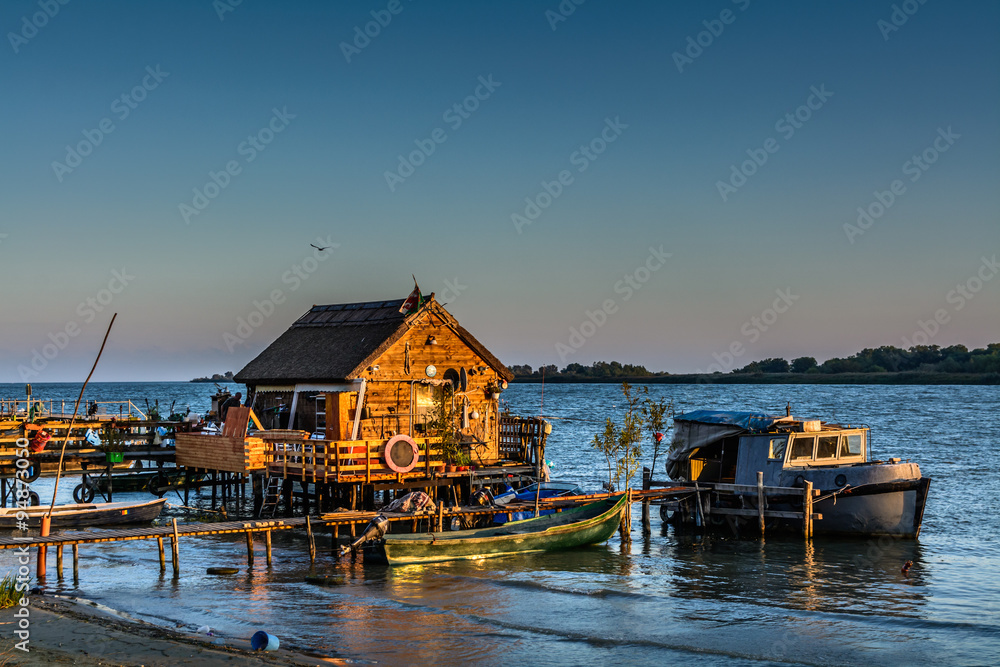 Fisherman's House, the old dock and the boat on the lake. Rustic