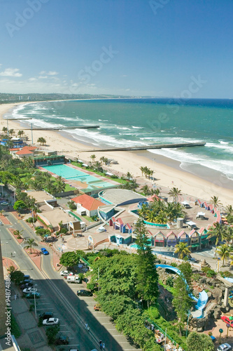 Aerial view of Indian Ocean, white sandy beaches, pool and ocean pier in the town center of Durban, South Africa