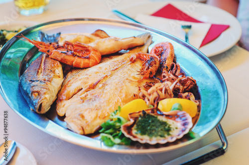 traditional slovenian food, fish plate with seafood, selective focus