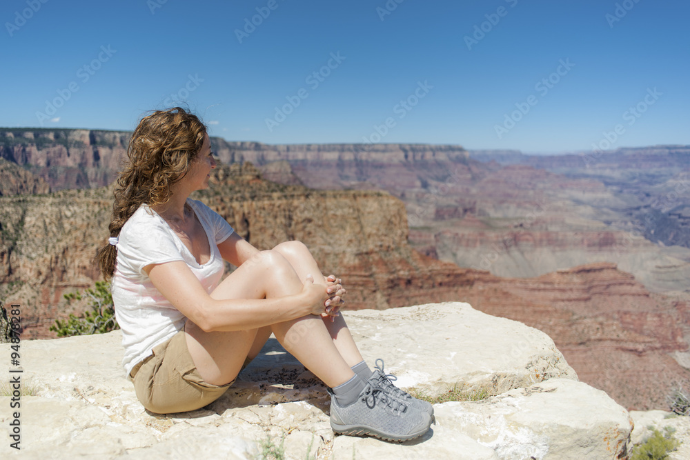 Woman enjoying Grand Canyon view on a summer sunny day