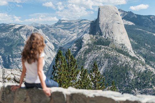 Woman at Glacier Point, in Yosemite National Park, looking at Half Dome