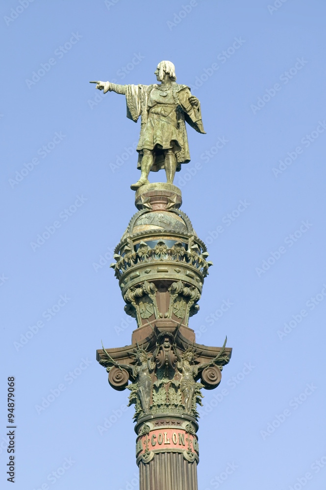 Statue of Christopher Columbus points west to New World, next to waterfront of Port Vell, Barcelona, Spain