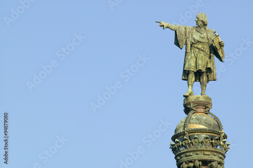 Statue of Christopher Columbus points west to New World, next to waterfront of Port Vell, Barcelona, Spain photo