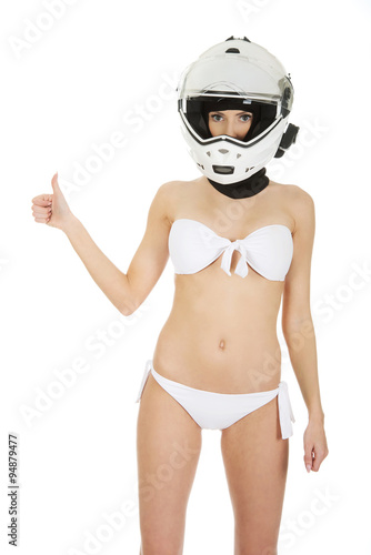 Woman in motorcycle helmet with thumbs up.