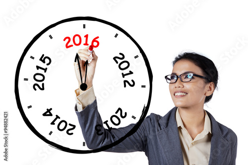 Businesswoman drawing an annual clock