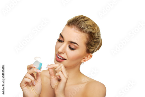 Young woman flossing her teeth.
