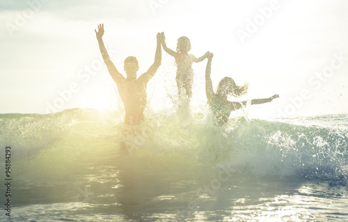 Happy family silhouette in the water